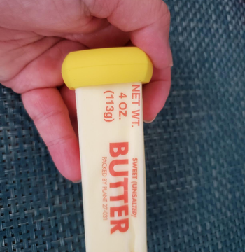 yellow hugger on the end of a stick of butter