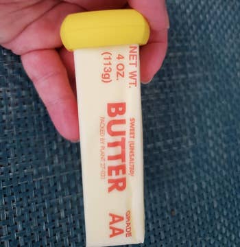 yellow hugger on the end of a stick of butter