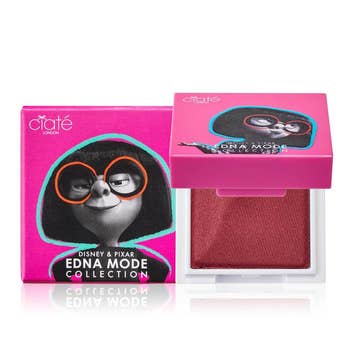 a pink square lip powder with edna mode on the front of the package