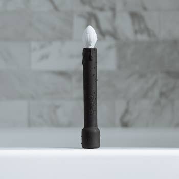 Black and white candle-shaped vibrator