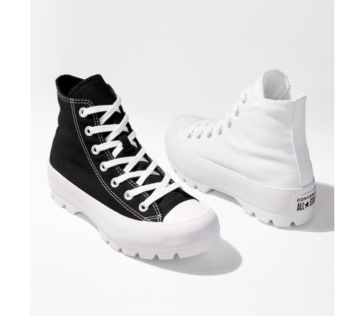 one black and one white Converse lace-up shoe with thick white sole
