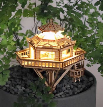 the same wooden model house illuminated from within 
