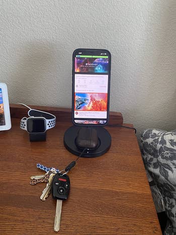 same reviewer's photo of stand charging iphone and airpods