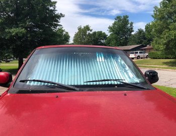 Reviewer image of car from outside showing reflective surface of the sunshade 