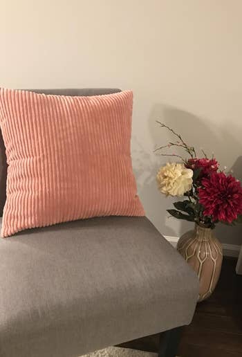 pink corduroy throw pillow on a chair