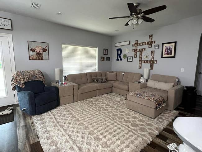 reviewer image of the beige area rug in a living room
