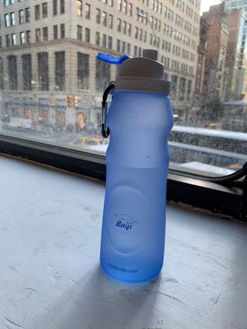 reviewer image of the blue collapsible bottle full of water