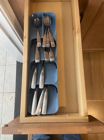 a reviewer's cutlery organizer in a small drawer