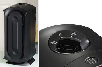 Black air purifier standing upright on a desk, closeup of top of product with adjustable knob