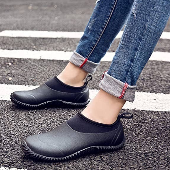 a model wearing the slip-on shoes in black 