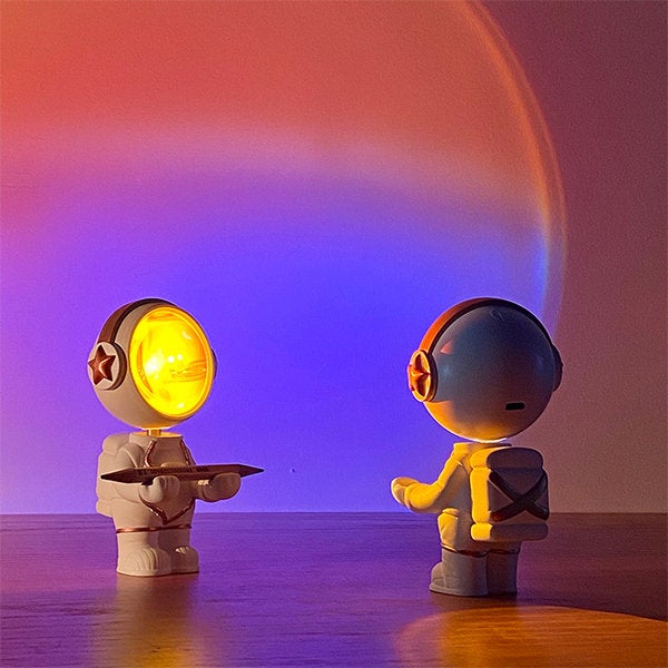 two of the astronaut sunset lamps facing each other