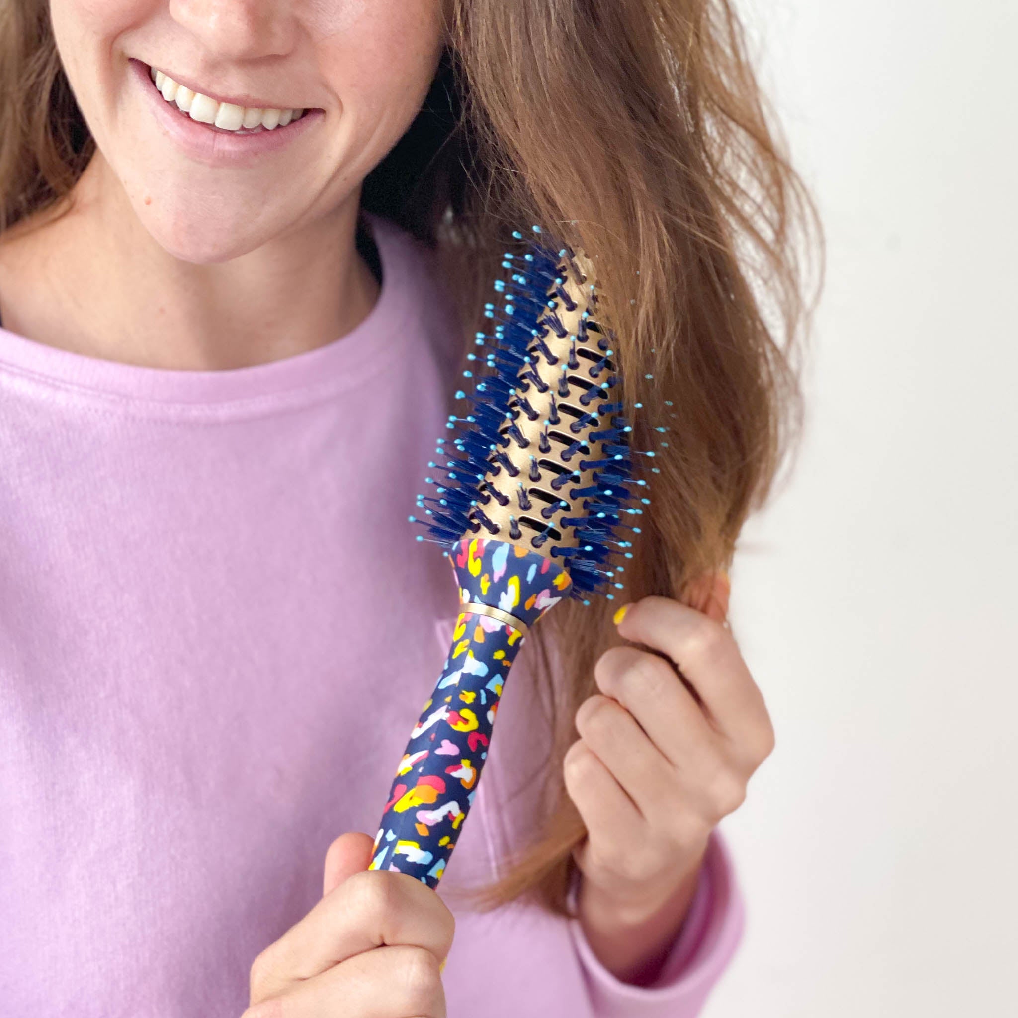 model using blue and rainbow leopard print round brush