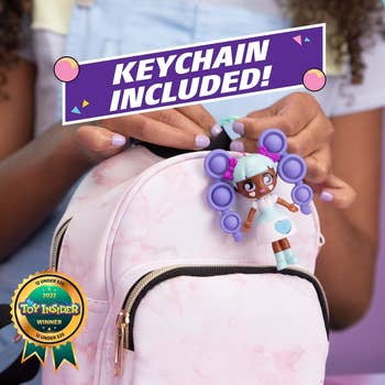 the fashion fidget connected to a backpack via included keychain