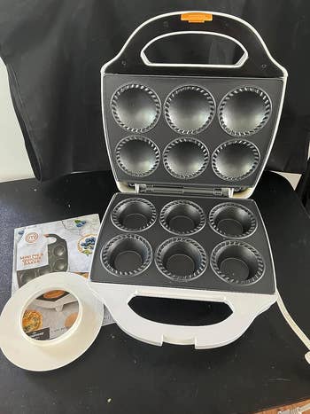 Reviewer's pie cooker open displaying six slots