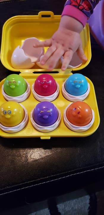 reviewer's child playing with the egg toy