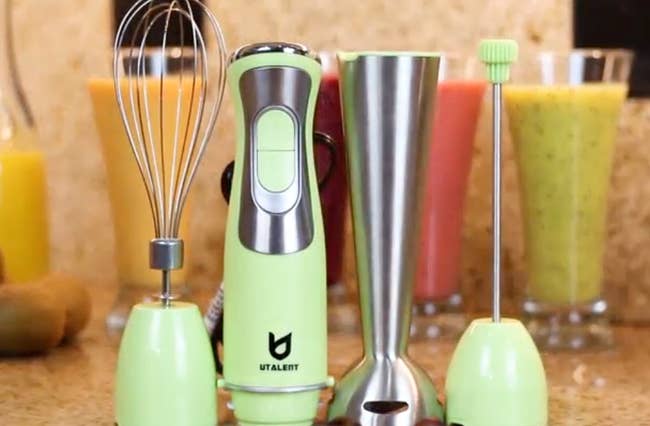 the green immersion blender with the attachments next to it