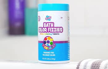 jar of bath fizzies on the ledge of a tub