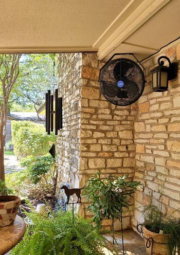 another reviewer's fan hanging in the corner of a covered patio