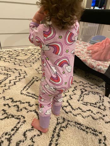 a back view of the child wearing the pajama sleeper