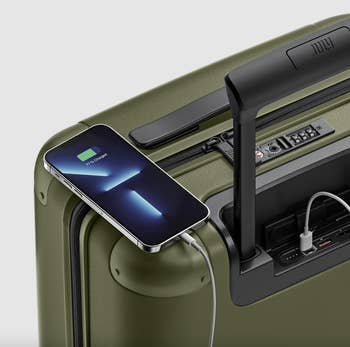 phone charging on olive suitcase