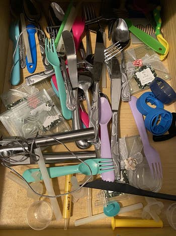 reviewer's drawer with silverware and cooking utensils messily tossed in it