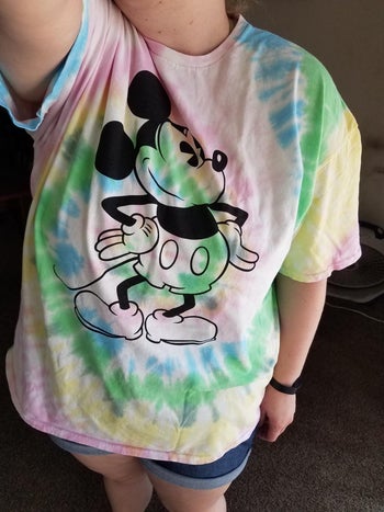 a reviewer in a rainbow tie dye mickey tee