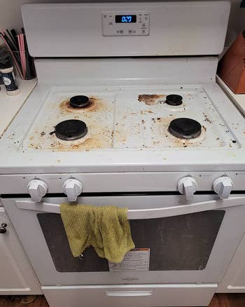 A reviewer's before photo which shows a white stove covered in rust and stains