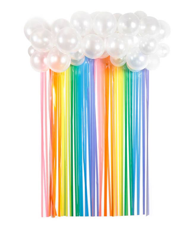 wall decoration made from shiny white balloons and rainbow streamers