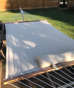 A close-up of the white hammock attached to the spreader bar