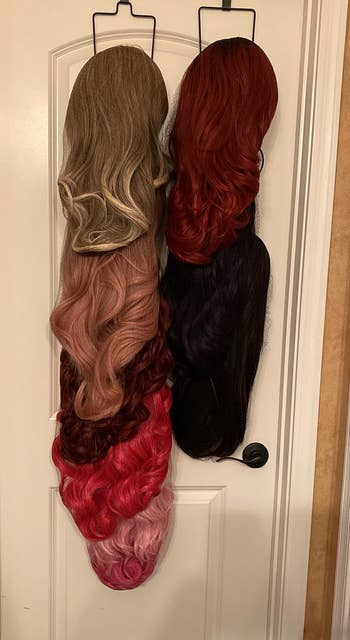 reviewer's wigs on a rack hanging over a door
