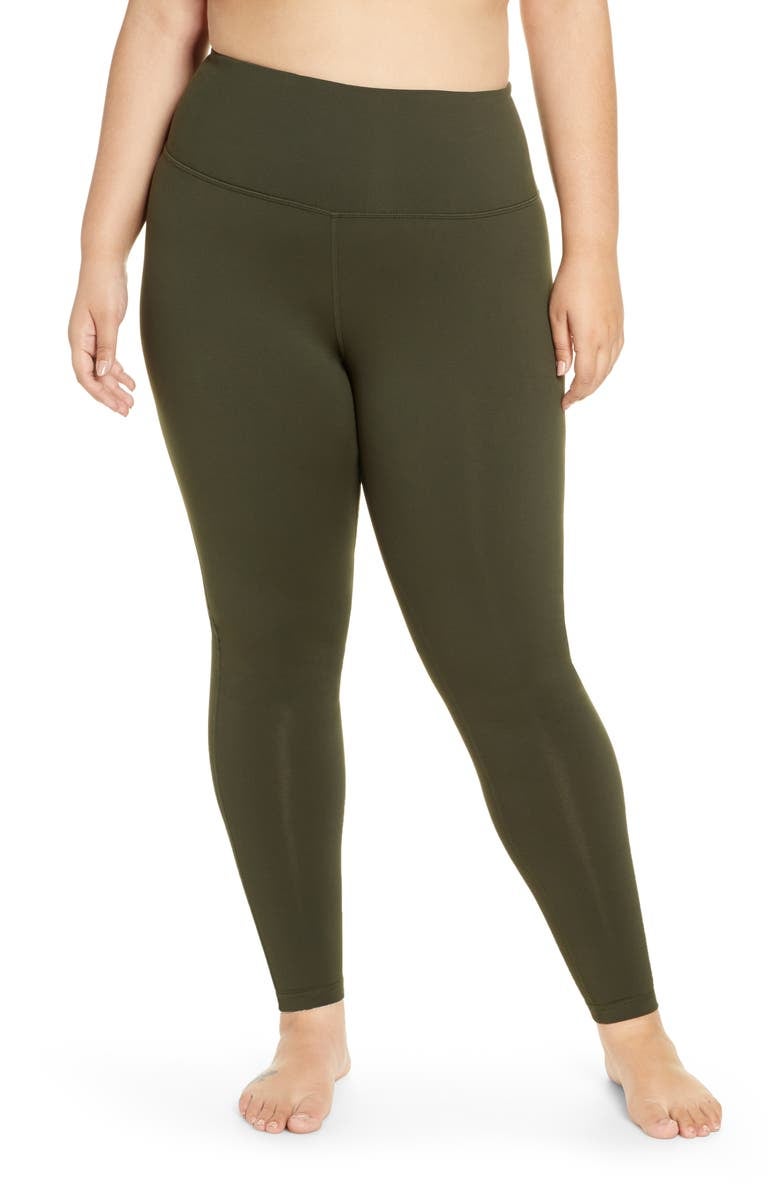 Model in a pair of olive green high waist leggings