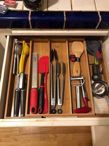 the reviewer's kitchen drawer now organized with the bamboo dividers