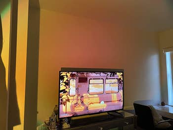 the sunset filter being cast across a room with a tv, giving a warm rosy glow