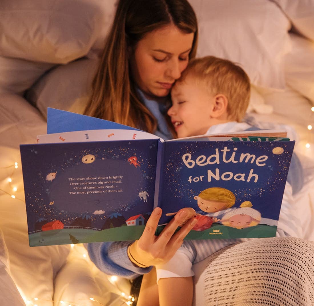 a mother and child reading a book that says