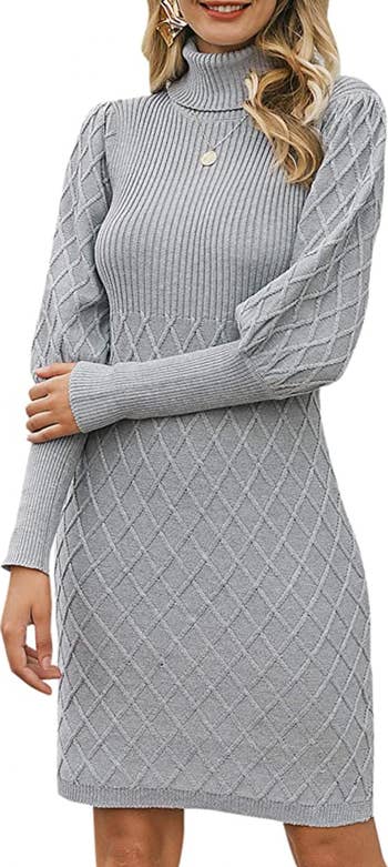 a model wearing the sweater dress in gray