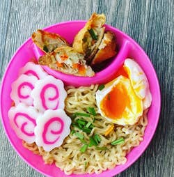 reviewer photo of ramen with a soft-boiled egg in a pink bowl