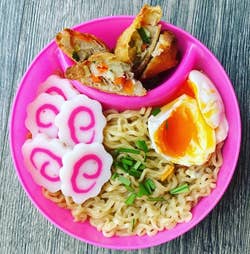reviewer photo of ramen with a soft-boiled egg in a pink bowl