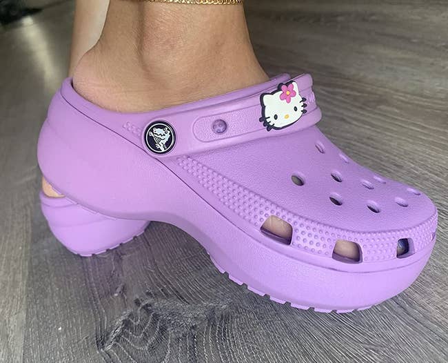 reviewer wearing the crocs in purple