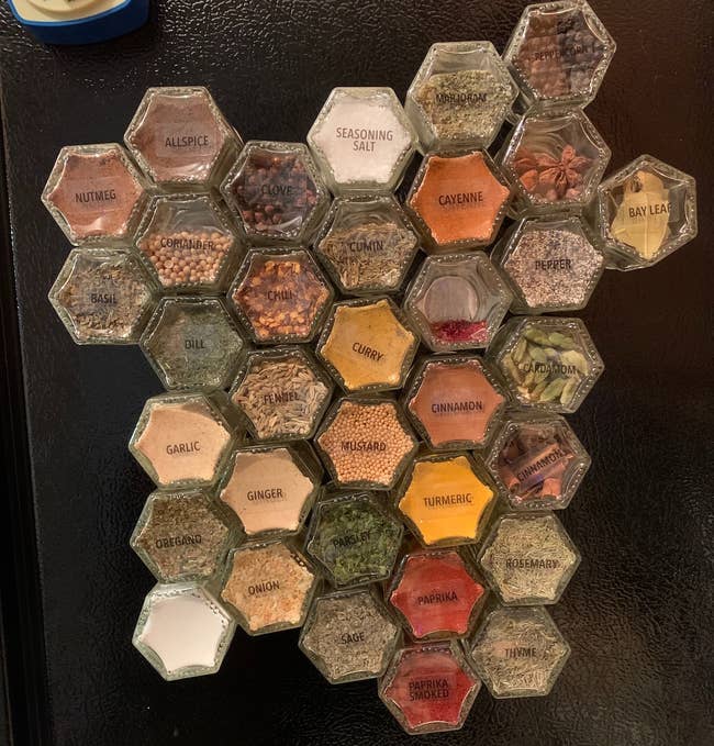 reviewer's glass magnetic spice jars with labels on side of fridge