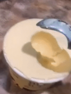 Reviewer without complications scooping ice cream out of the pint 