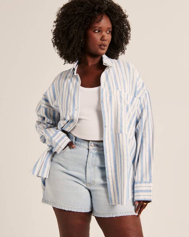 model wearing blue and white striped shirt