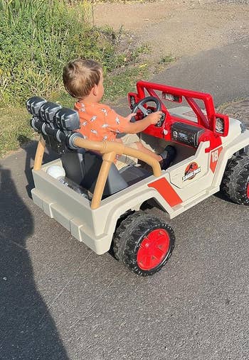 image of reviewer's child sitting in the jurassic park jeep
