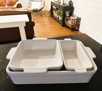 Stacked achromatic  baking dishes connected  a room  counter, with a cozy surviving  country  successful  the background