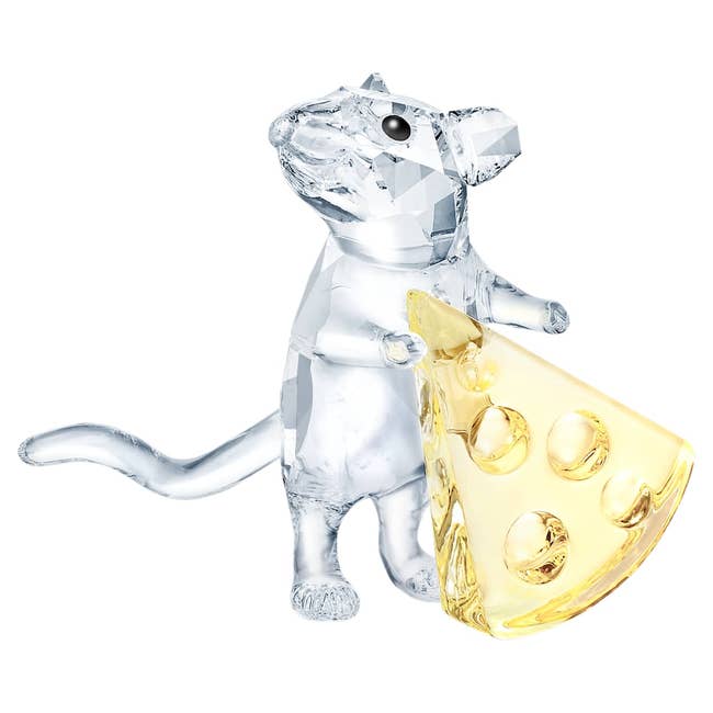 Crystal rodent figurine holding a portion of cheese, showcasing elaborate craftsmanship successful an elegant, decorative design
