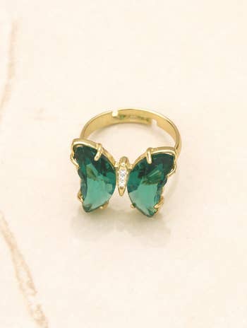 ring with green jewel wings