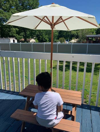 reviewer photo of young boy sitting at picnic table