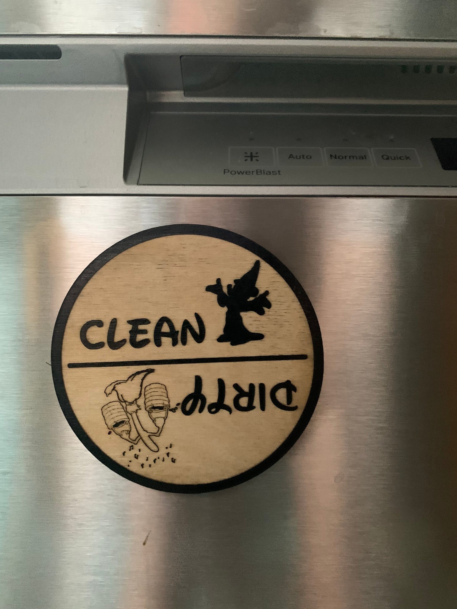 the disney inspired clean and dirty dishwasher magnet on a dishwasher