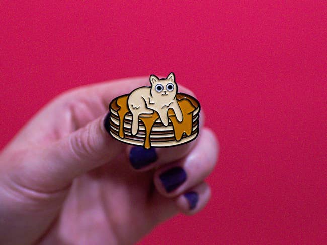 enamel pin with a stack of pancakes with a melting butter cat on top