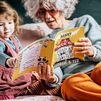 a grandma reading storybook to a baby