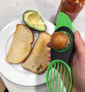reviewer photo of the tool holding an avocado pit
